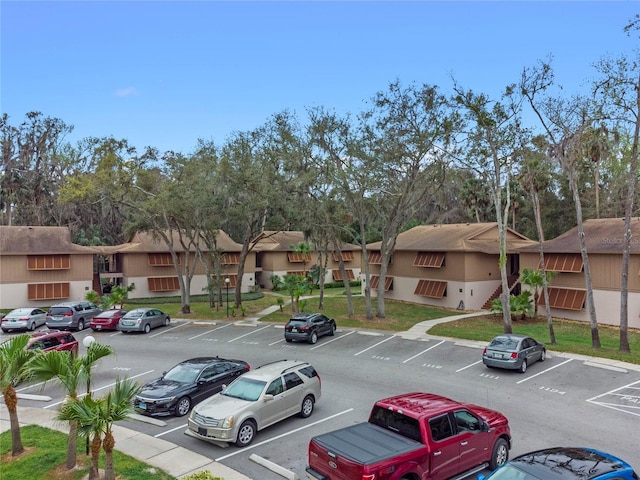 uncovered parking lot featuring a residential view