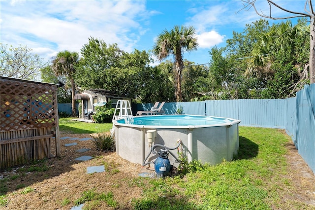 view of swimming pool featuring a fenced in pool, a fenced backyard, and a yard