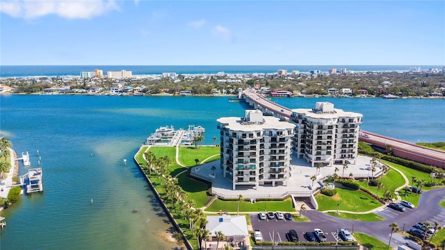 drone / aerial view featuring a water view and a view of city