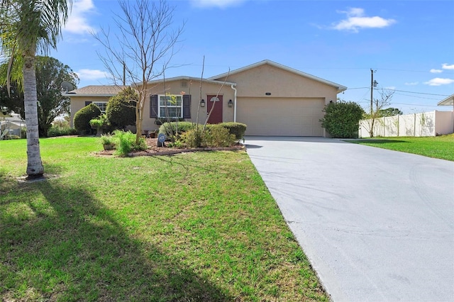 ranch-style home featuring concrete driveway, stucco siding, an attached garage, fence, and a front yard