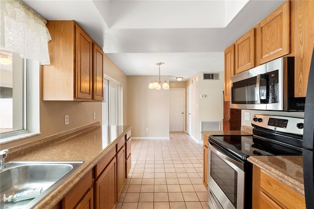 kitchen featuring a sink, a chandelier, light tile patterned floors, appliances with stainless steel finishes, and visible vents