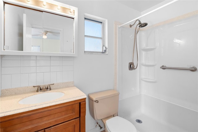 full bath featuring toilet, walk in shower, tasteful backsplash, and vanity