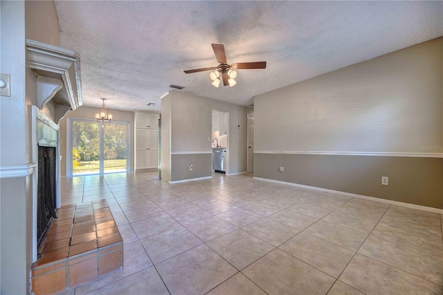 spare room featuring visible vents, light tile patterned flooring, a textured ceiling, baseboards, and ceiling fan with notable chandelier