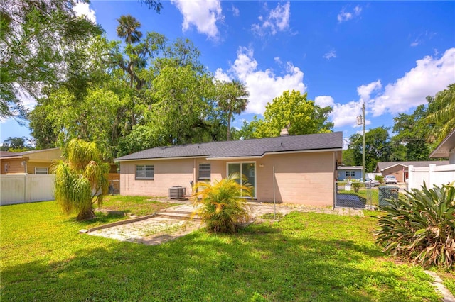 741 Greenway Pl, Daytona Beach, FL 32114 - back of property featuring central AC, a chimney, and a patio area