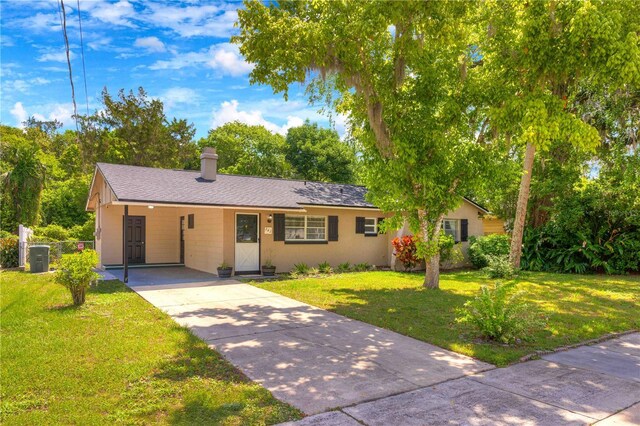 741 Greenway Pl, Daytona Beach, FL 32114 - single story home featuring driveway, a carport, a front yard, and a chimney