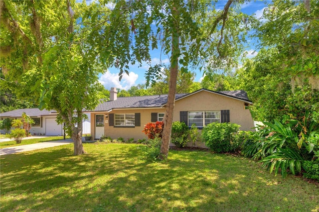 741 Greenway Pl, Daytona Beach, FL 32114 - view of front of house with a garage, stucco siding, a chimney, and a front yard