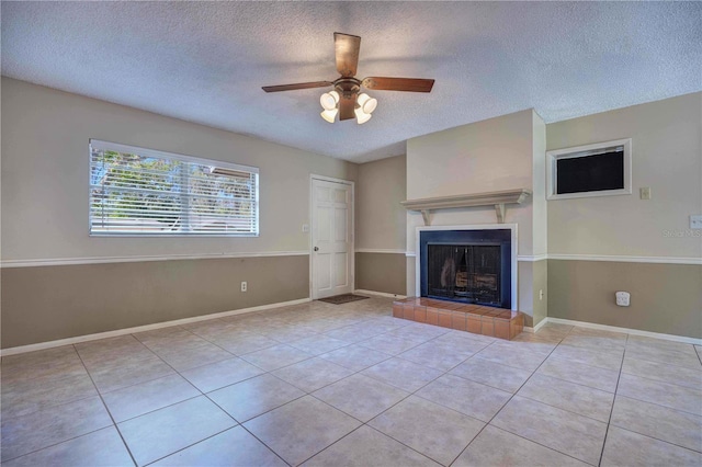 741 Greenway Pl, Daytona Beach, FL 32114 - unfurnished living room featuring a textured ceiling, tile patterned floors, a ceiling fan, a tile fireplace, and baseboards