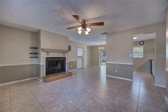 741 Greenway Pl, Daytona Beach, FL 32114 - unfurnished living room with a ceiling fan, a textured ceiling, light tile patterned floors, a tile fireplace, and baseboards