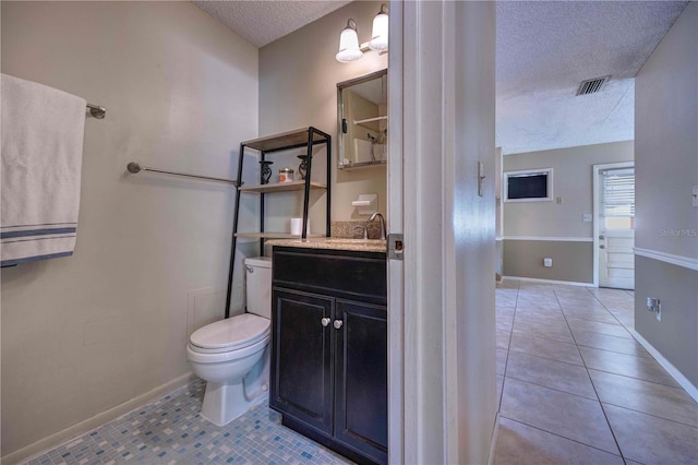 741 Greenway Pl, Daytona Beach, FL 32114 - bathroom with a textured ceiling, tile patterned flooring, toilet, vanity, and baseboards