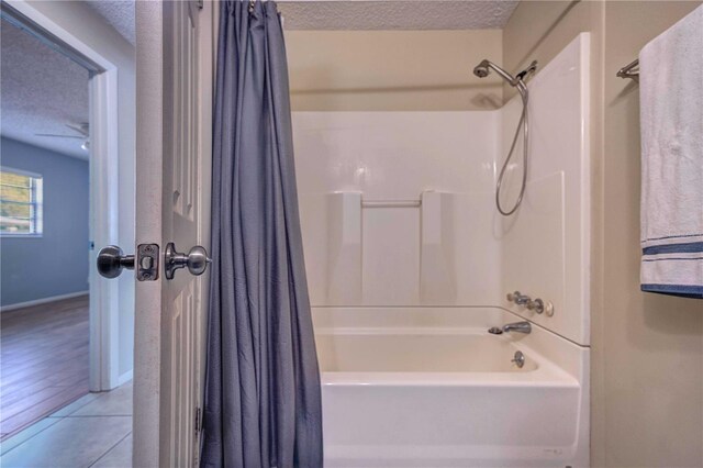 741 Greenway Pl, Daytona Beach, FL 32114 - full bathroom featuring a textured ceiling, shower / bath combination with curtain, baseboards, and tile patterned flooring