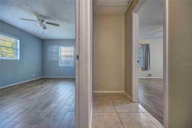 741 Greenway Pl, Daytona Beach, FL 32114 - unfurnished room with a textured ceiling, a ceiling fan, light wood-type flooring, and baseboards