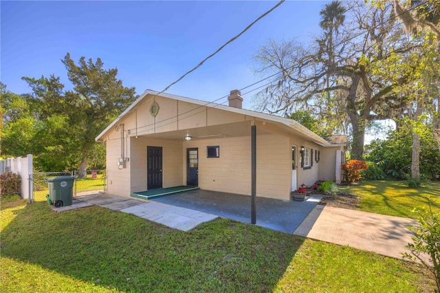 741 Greenway Pl, Daytona Beach, FL 32114 - rear view of property featuring a chimney, an attached carport, and a gate