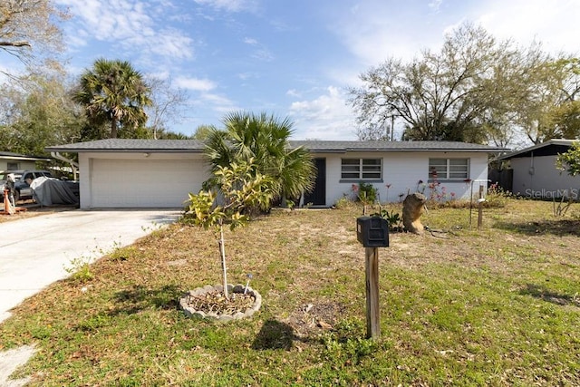 single story home with driveway, an attached garage, and a front yard