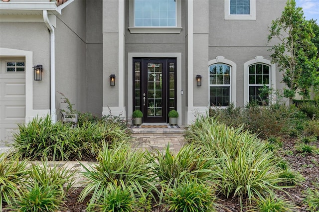 view of exterior entry featuring stucco siding