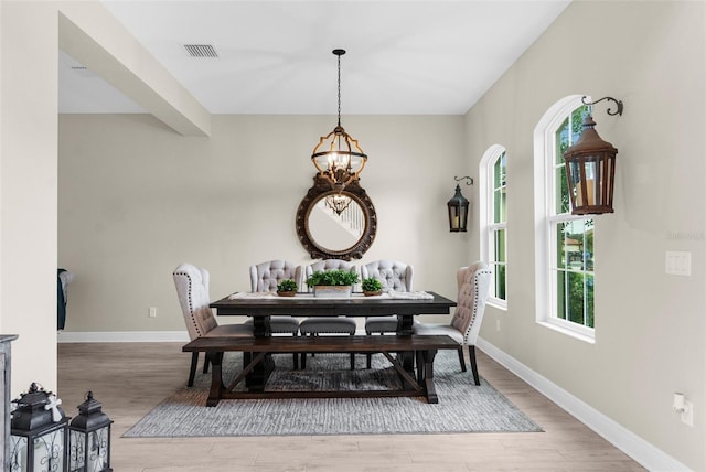32924 Estate Garden Dr, Wesley Chapel, FL 33545 - dining room featuring baseboards, light wood-type flooring, visible vents, and a notable chandelier