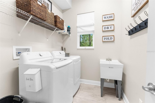 32924 Estate Garden Dr, Wesley Chapel, FL 33545 - laundry room featuring baseboards, laundry area, light wood finished floors, and washer and dryer