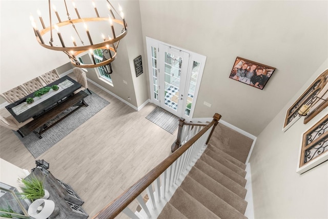 32924 Estate Garden Dr, Wesley Chapel, FL 33545 - interior space featuring baseboards, a towering ceiling, an inviting chandelier, and wood finished floors