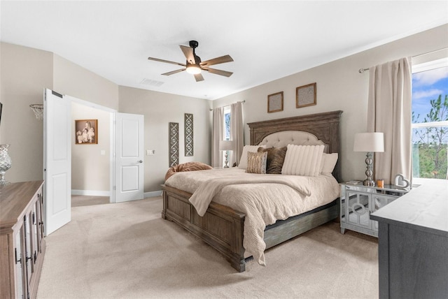 32924 Estate Garden Dr, Wesley Chapel, FL 33545 - bedroom with light carpet, baseboards, visible vents, and a ceiling fan