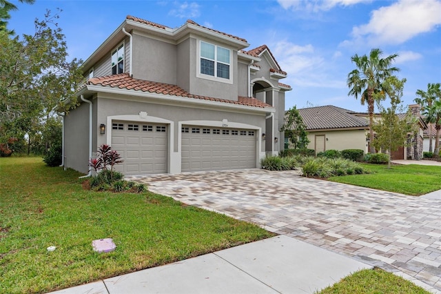 32924 Estate Garden Dr, Wesley Chapel, FL 33545 - mediterranean / spanish house with a garage, a tile roof, decorative driveway, stucco siding, and a front lawn