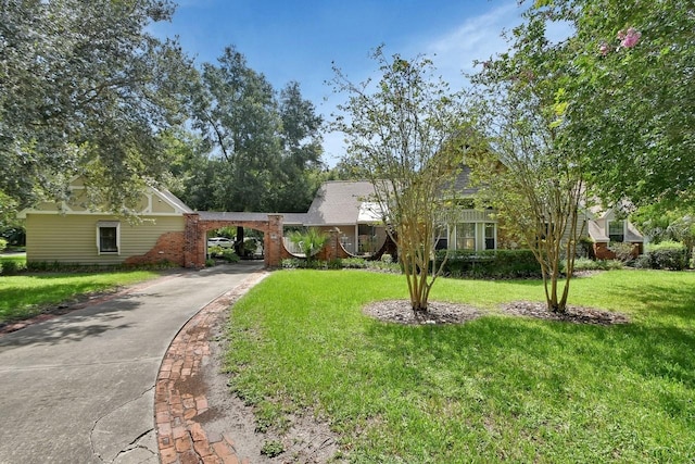 ranch-style home featuring a carport, concrete driveway, and a front lawn