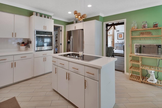 kitchen with stainless steel appliances, light countertops, white cabinets, and a kitchen island