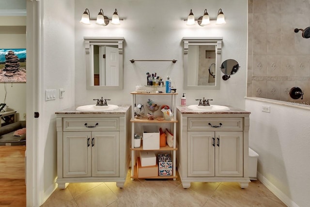 full bath featuring tile patterned flooring, two vanities, and a sink