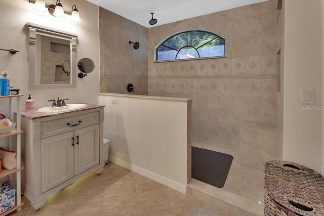 bathroom featuring a walk in shower and vanity