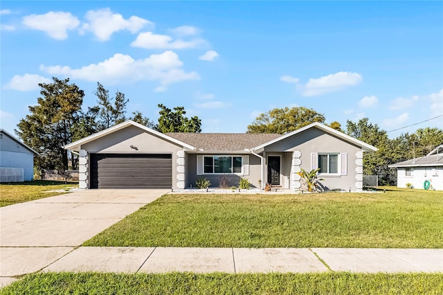 ranch-style home featuring a garage, driveway, a front yard, and stucco siding