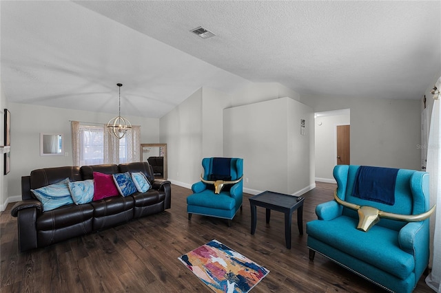 living area featuring lofted ceiling, visible vents, a notable chandelier, and wood finished floors