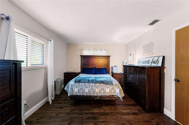 bedroom featuring dark wood-type flooring, radiator, a textured ceiling, and baseboards