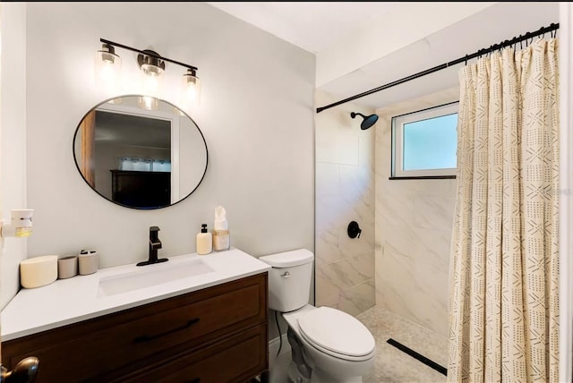 bathroom with toilet, a tile shower, and vanity