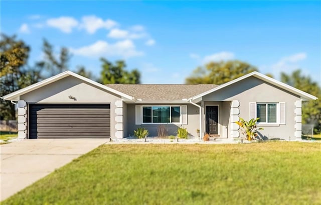 single story home with a garage, a front yard, concrete driveway, and stucco siding