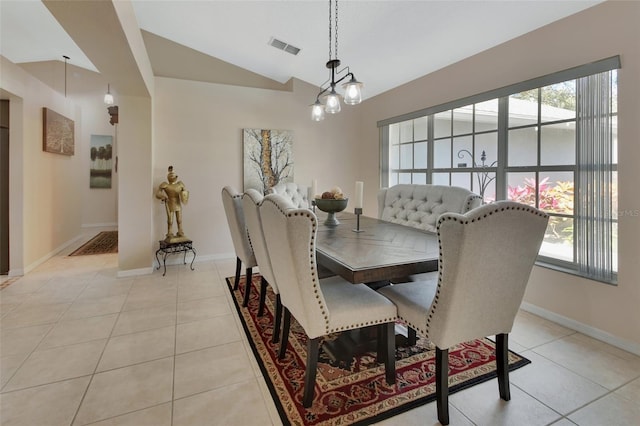 dining area with lofted ceiling, light tile patterned floors, visible vents, and baseboards