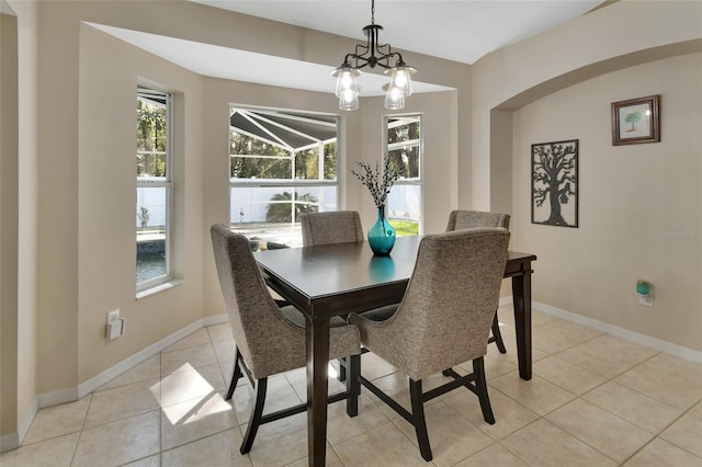 dining space featuring light tile patterned floors, a wealth of natural light, and baseboards