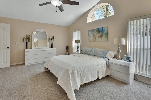 bedroom with lofted ceiling, carpet flooring, and a ceiling fan