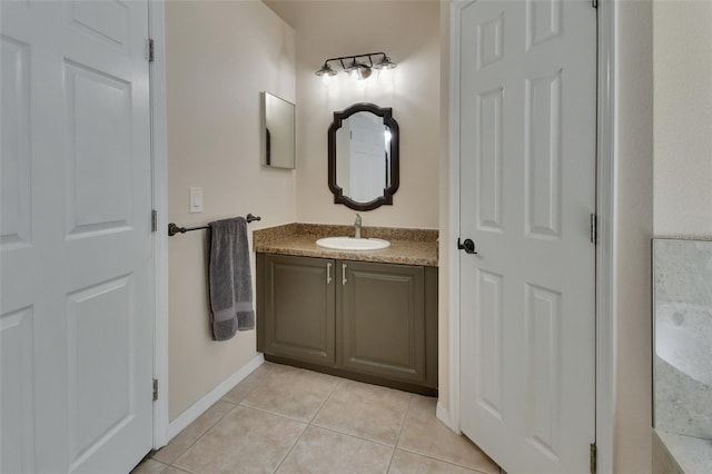 bathroom featuring tile patterned flooring, vanity, and baseboards