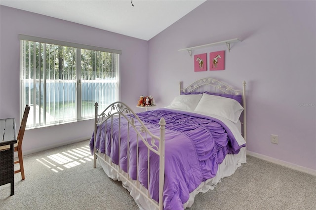 carpeted bedroom featuring lofted ceiling and baseboards