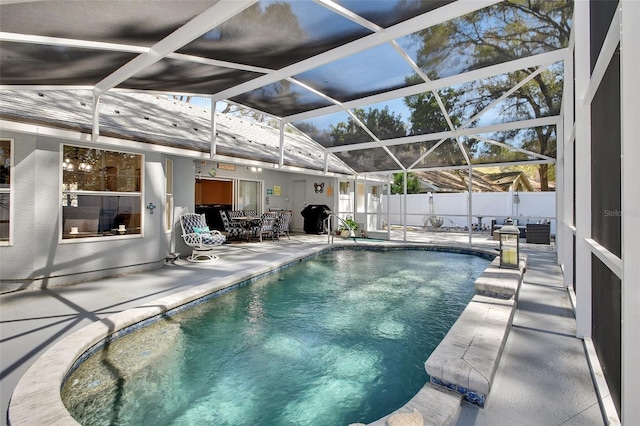 view of pool with a fenced in pool, outdoor dining area, glass enclosure, a patio area, and fence