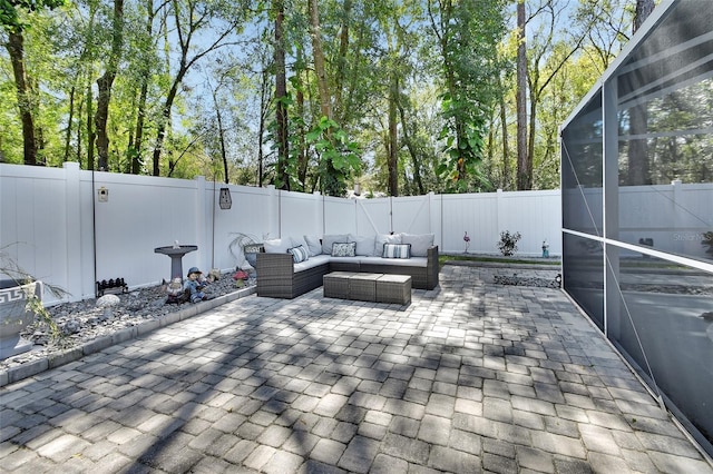 view of patio featuring a lanai, a fenced backyard, and outdoor lounge area