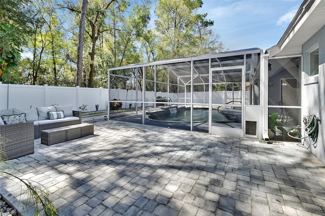 view of patio / terrace featuring a lanai, a fenced backyard, and outdoor lounge area