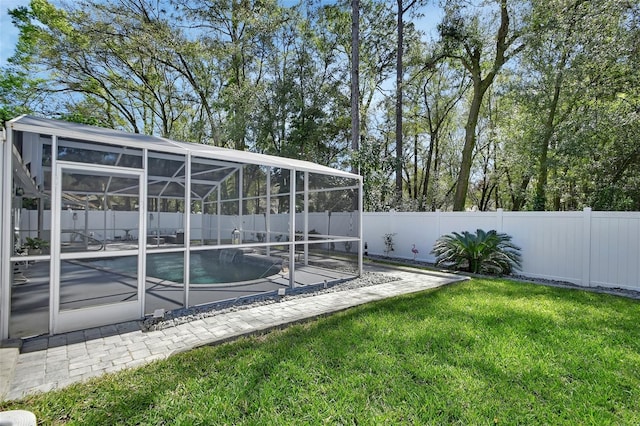 view of yard featuring a fenced in pool, a patio area, a lanai, and a fenced backyard