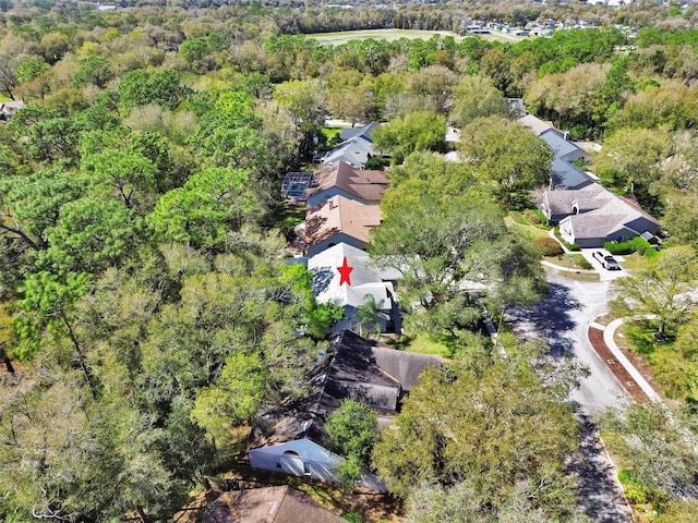 bird's eye view with a wooded view