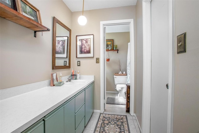 bathroom with toilet, baseboards, vanity, and tile patterned floors