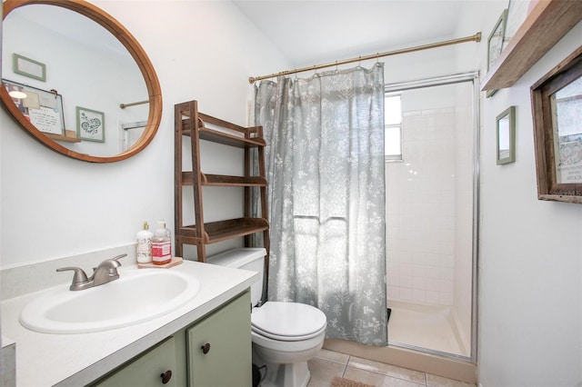 full bathroom featuring toilet, a shower stall, tile patterned flooring, and vanity