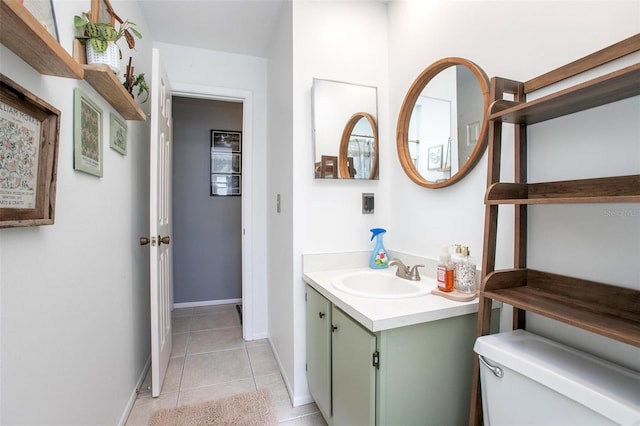 bathroom featuring tile patterned flooring, vanity, toilet, and baseboards