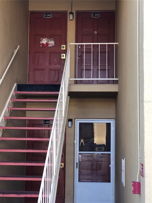 property entrance featuring stucco siding