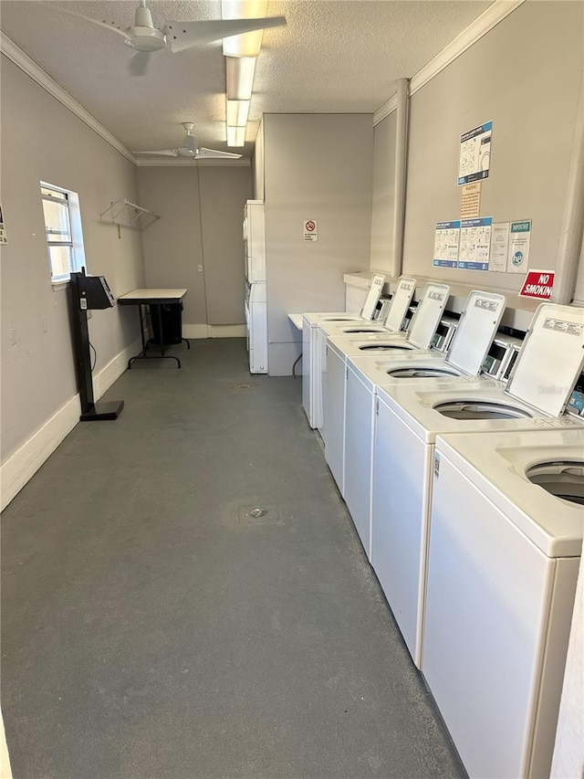 shared laundry area featuring crown molding, a textured ceiling, baseboards, and washer and dryer