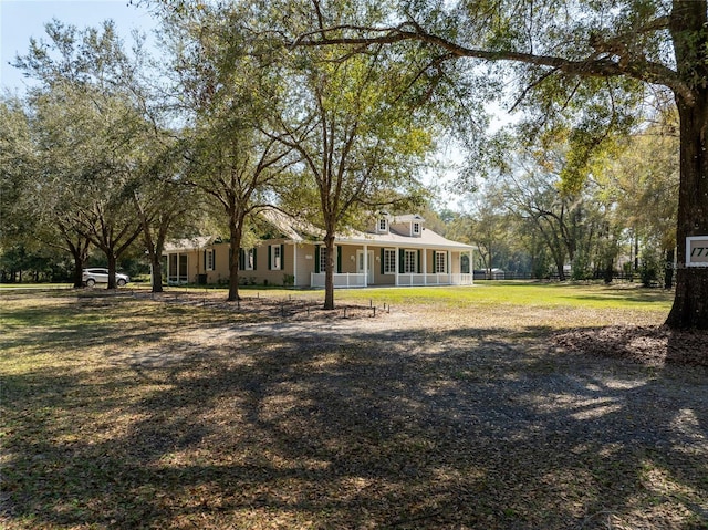 exterior space with a front yard and covered porch