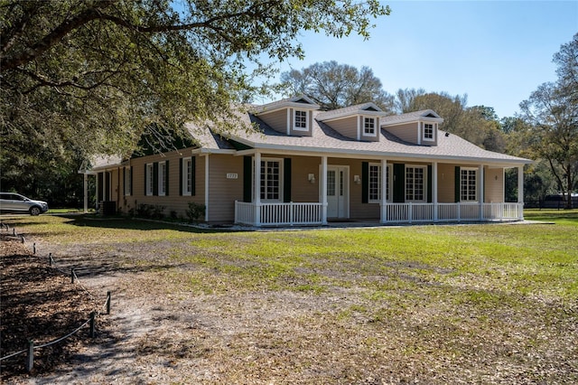 view of front of house with a porch, a front yard, and central air condition unit