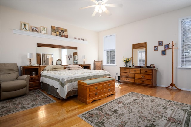 bedroom with light wood-style flooring and a ceiling fan